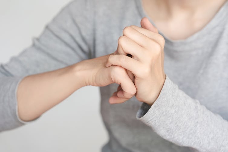 A person cracking their knuckles.