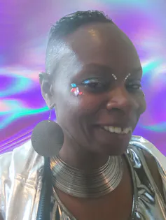 Author in face jewels and silver clothes
