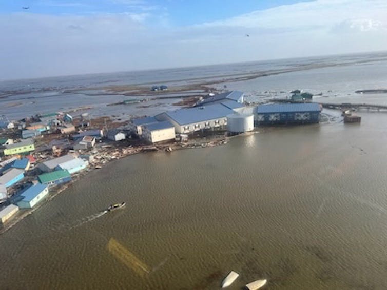 Homes are jumbled together and buildings are surrounded by water after the storm.