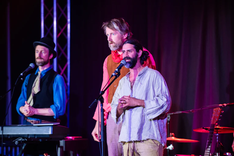 Three actors on stage.
