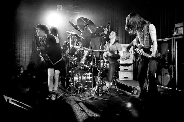 Black and white photo of the band on stage.