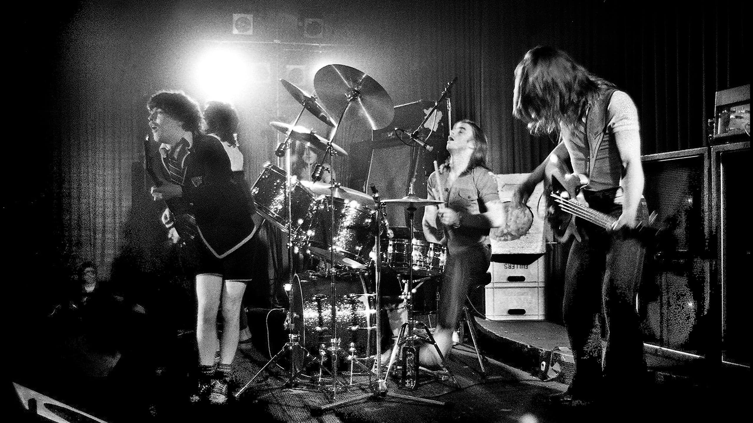 Black and white photo of the band on stage.