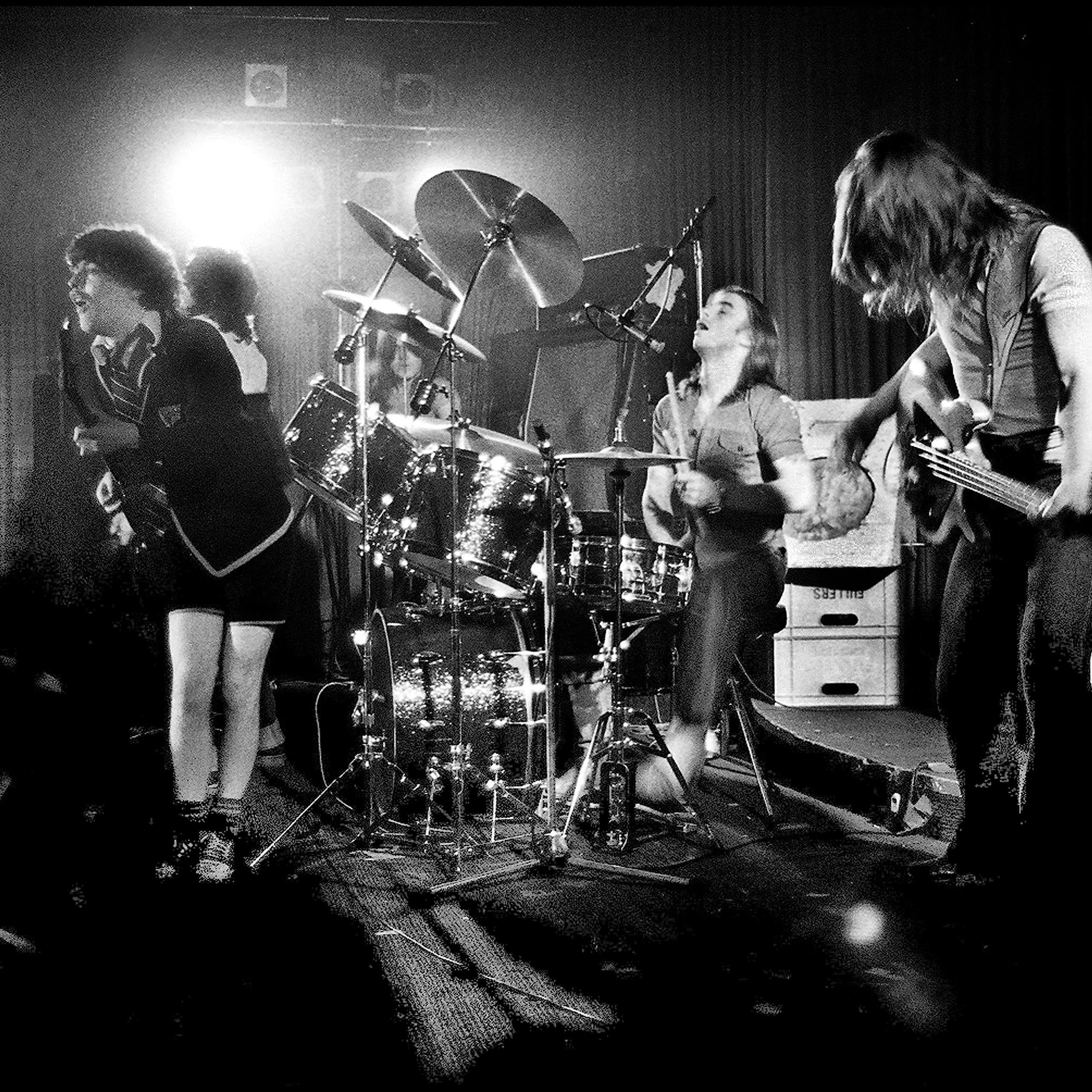 Black and white photo of the band on stage.