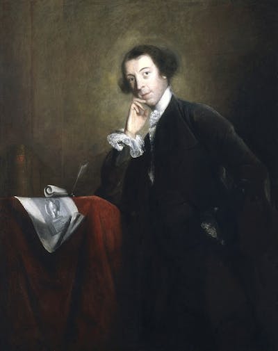 Ghostly portrait of a man leaning on a red chair