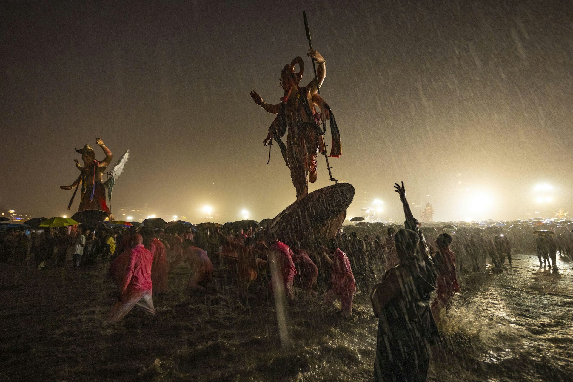 Statues emerge dramatically from torrential rain