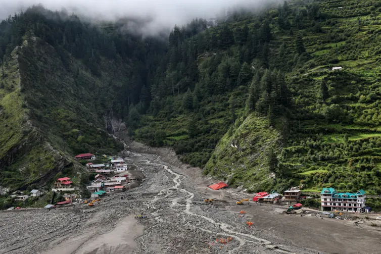 Steep mountainside with rocky debris covering village