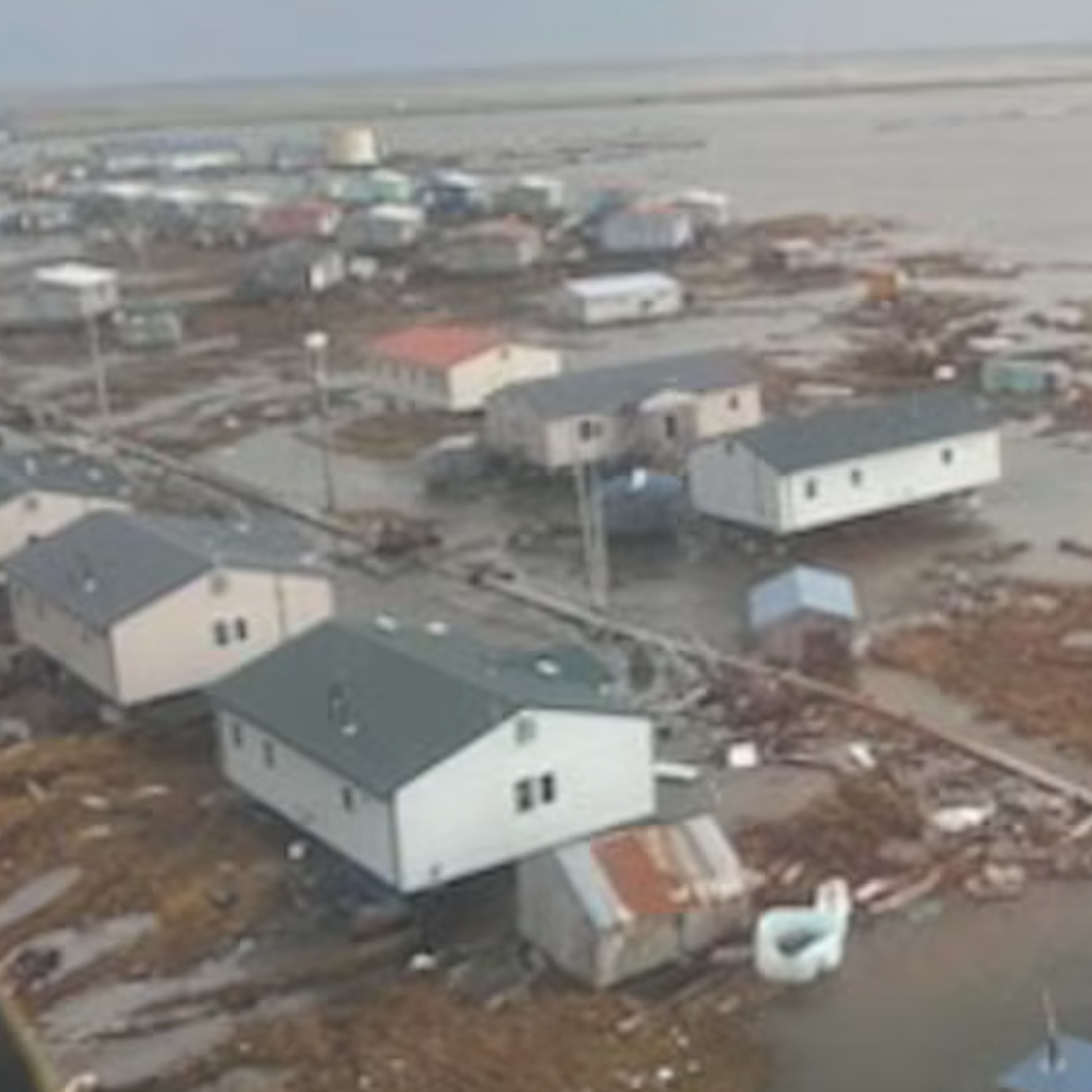 A view from a helicopter of floodwater surrounding homes.