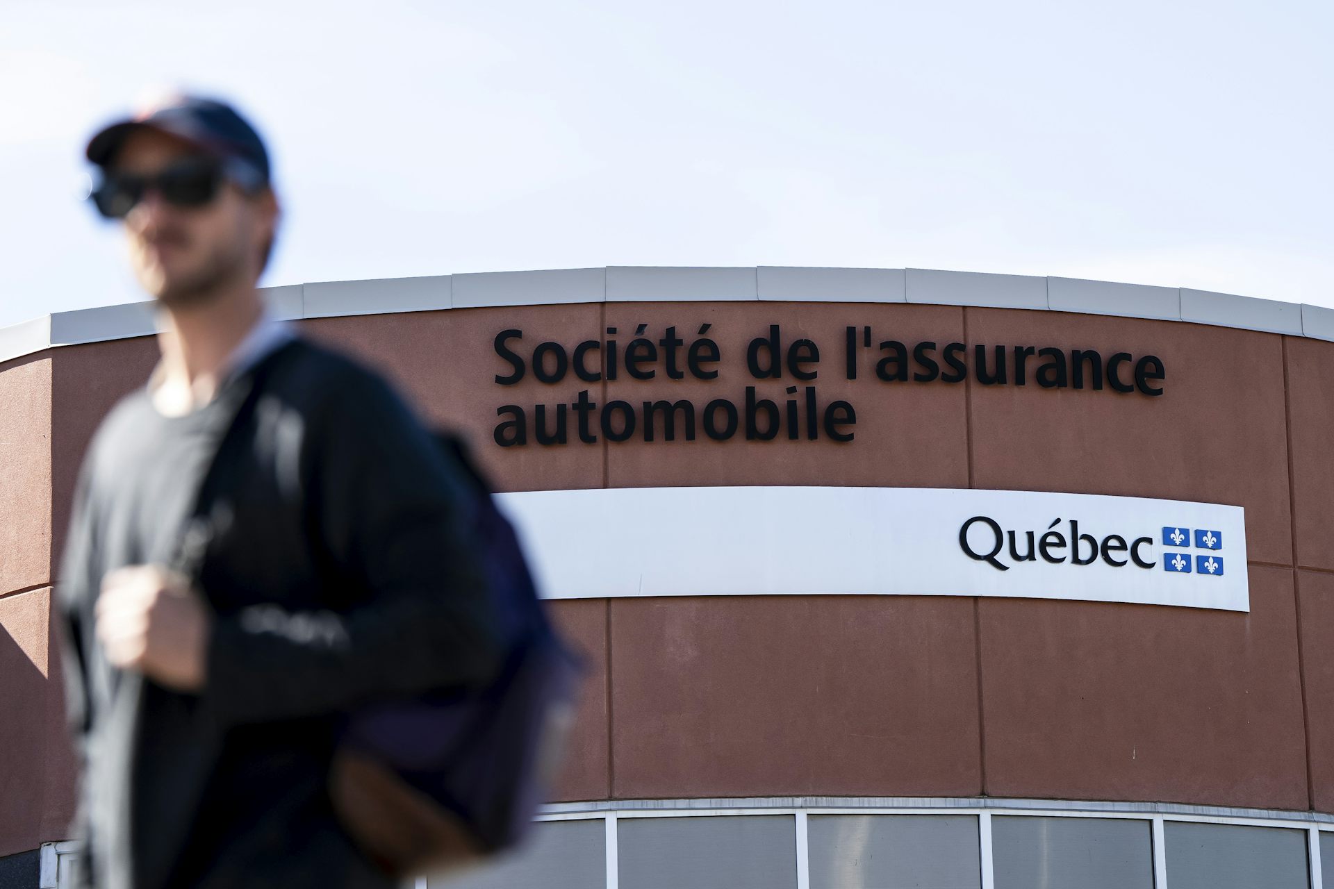 Un homme marche devant un bureau de la SAAQ