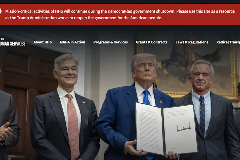 A red banner across a government website, with a message that claims the 'Mission-critical activities of HHS will continue during the Democrat-led government shutdown.'