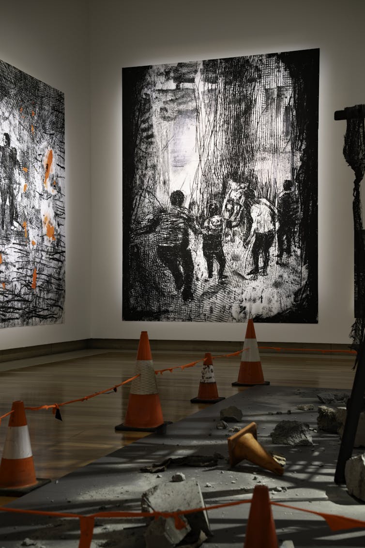 A large print behind orange cones.