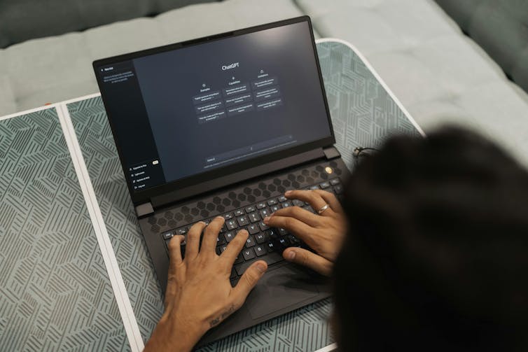 man using ChatGPT AI on a laptop