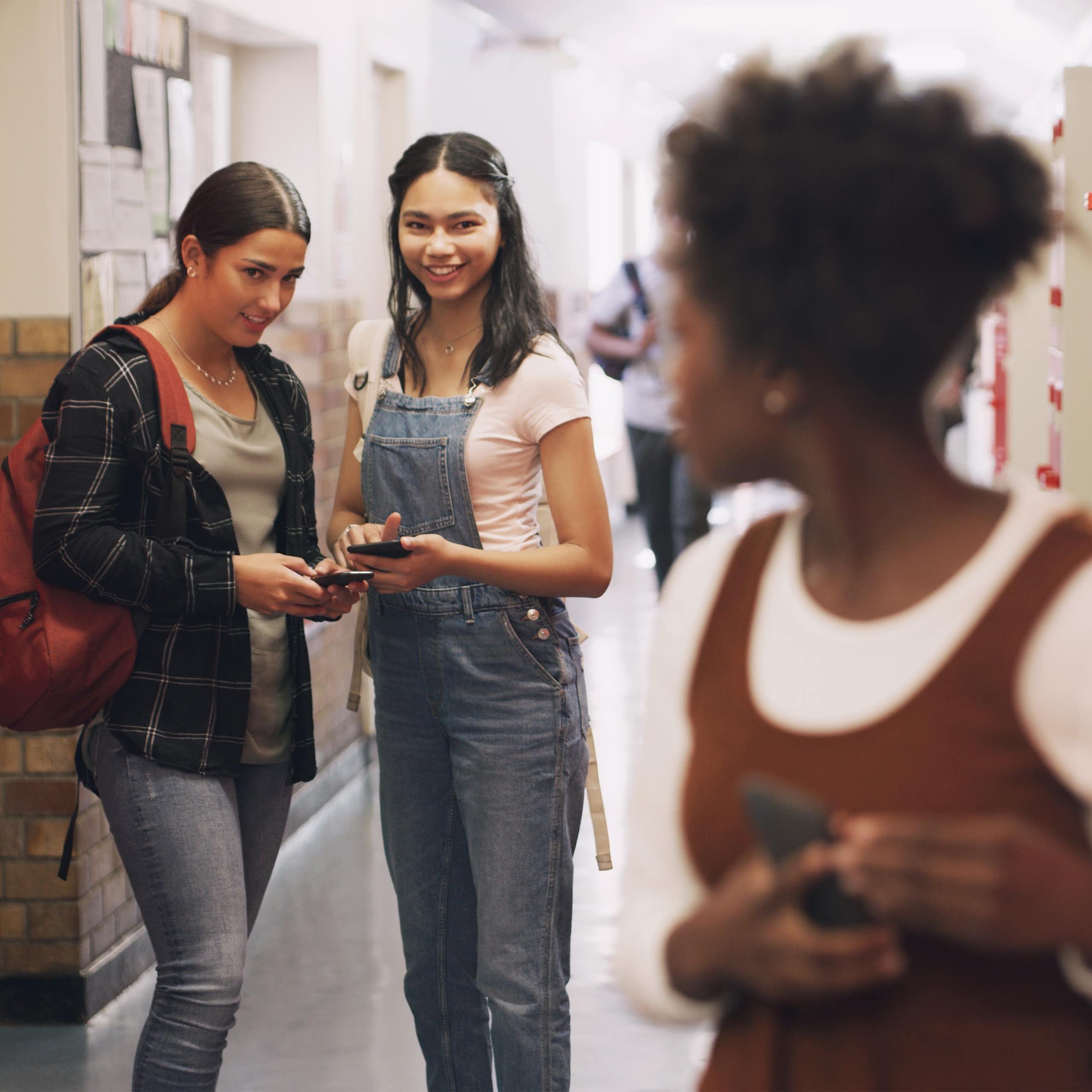 School bully and a girl with a phone for a secret, gossip or rude message online.