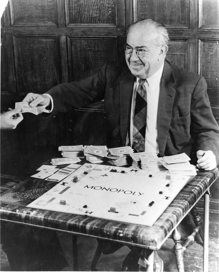 Photograph of an old man with a Monopoly board.