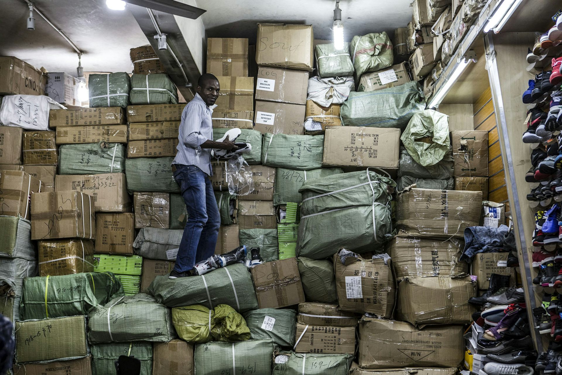 A worker unpacks goods at a Johannesburg CBD shop that also acts as a storeroom