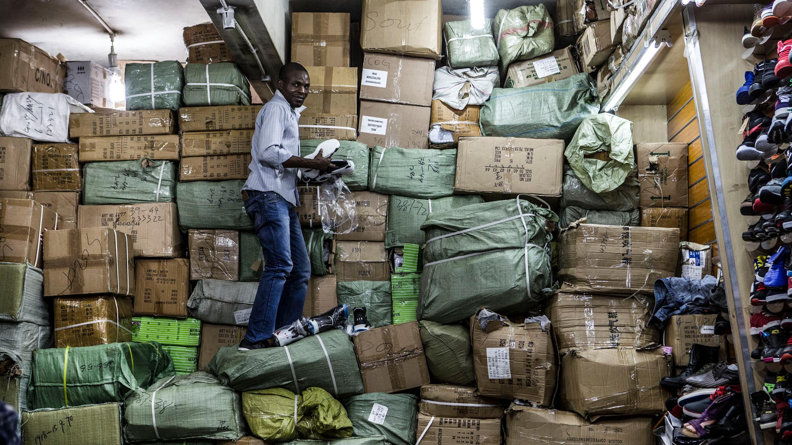 A worker unpacks goods at a Johannesburg CBD shop that also acts as a storeroom