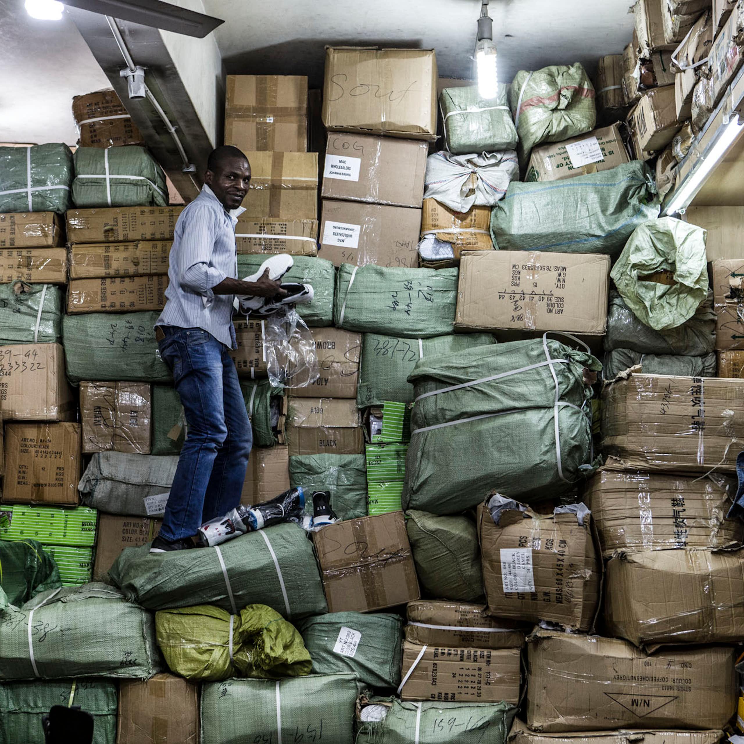 A worker unpacks goods at a Johannesburg CBD shop that also acts as a storeroom