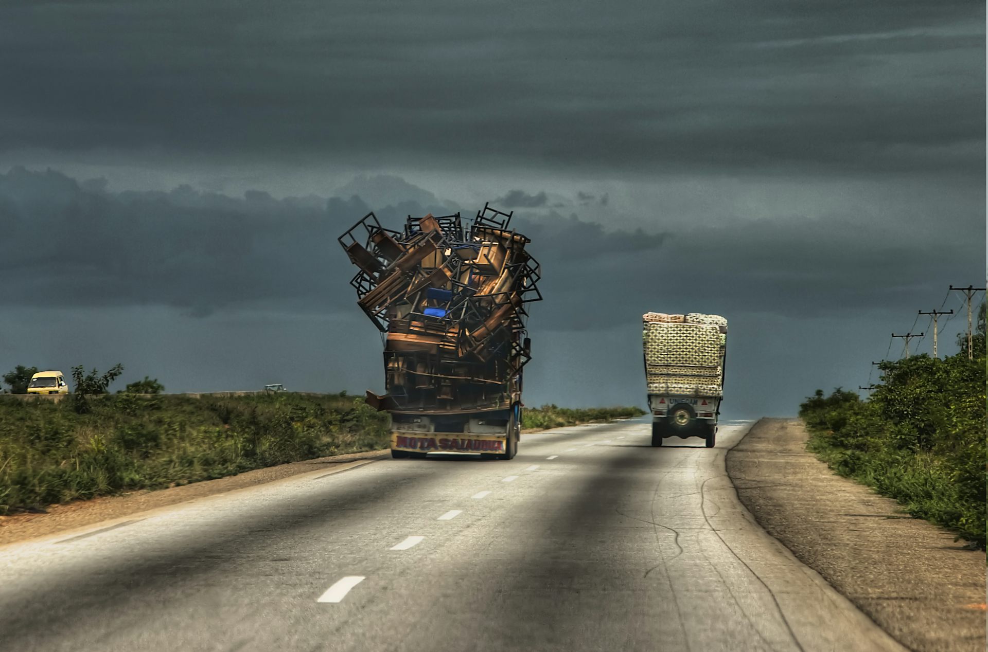 Heavily overloaded trucks on a road