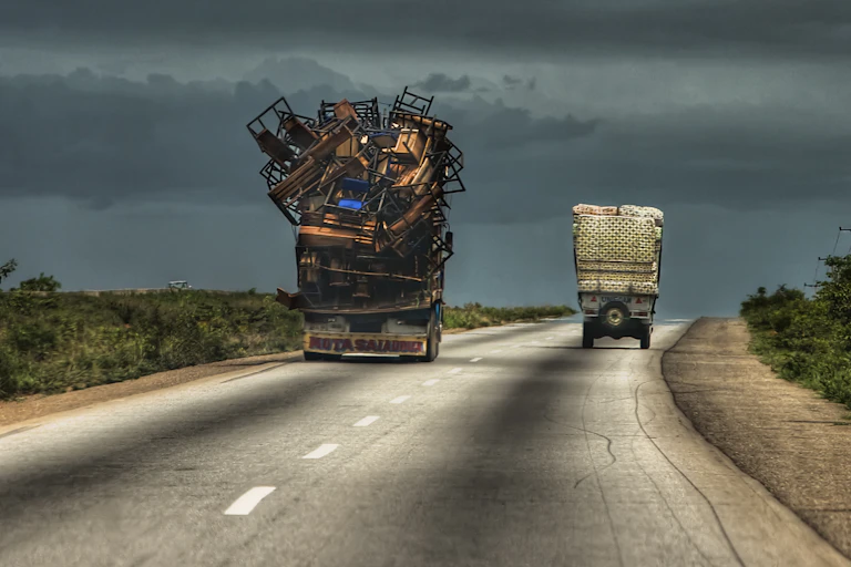 Heavily overloaded trucks on a road