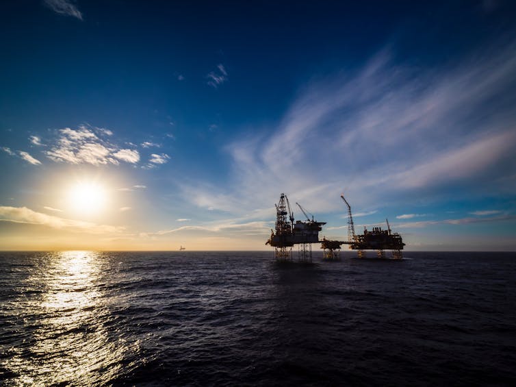 an oil rig in the north sea at sunset