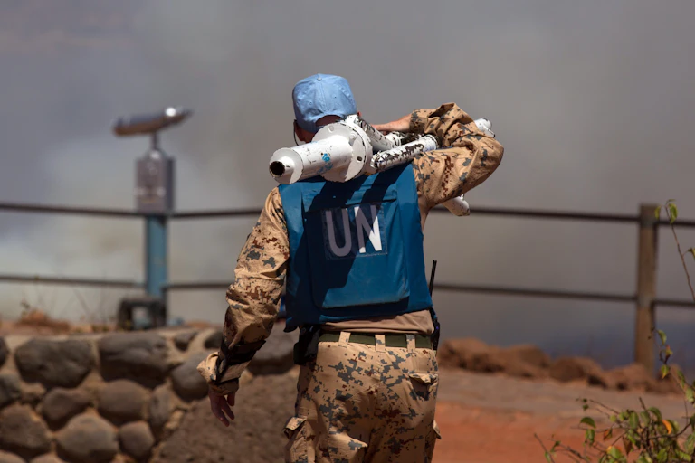 An UN peacekeeper carrying equipment.