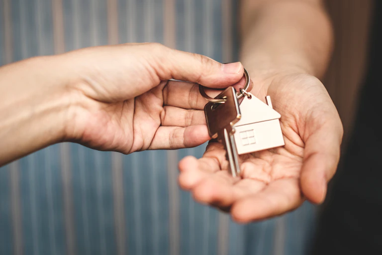 a set of house keys changing hands