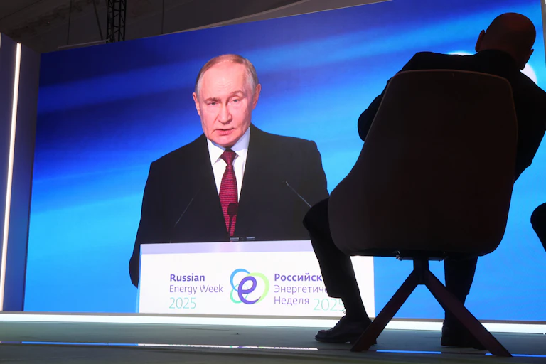 Russian president Vladimir Putin with his shadow stretching behind him.