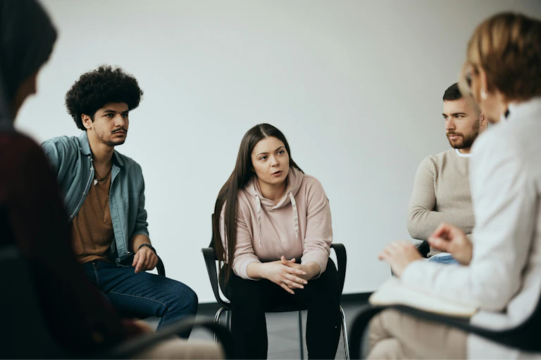 People sitting in a circle in discussion.