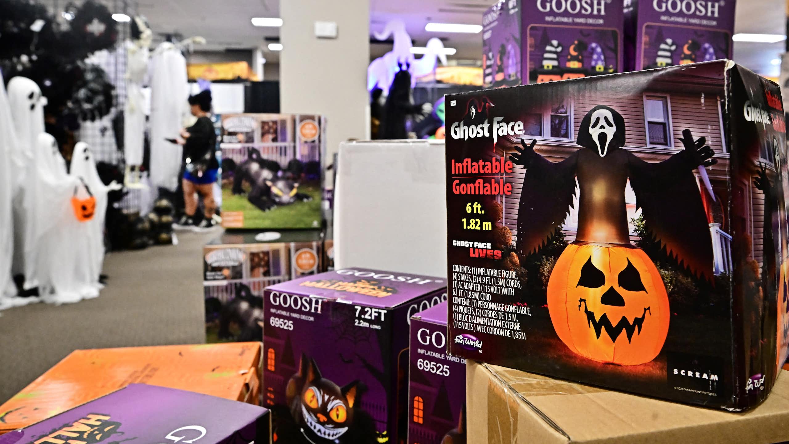 Boxes of ghost-themed Halloween lawn decorations are seen in a store.
