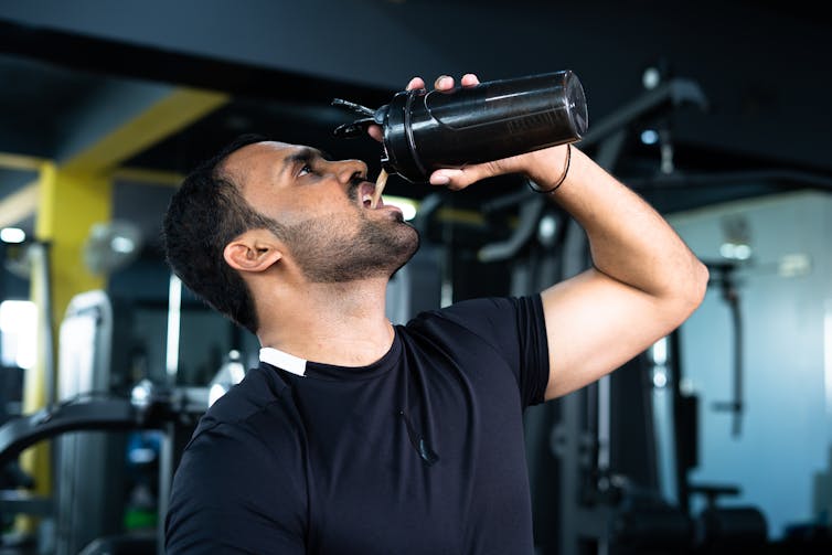 Bodybuilder at the gym drinking a protein shake