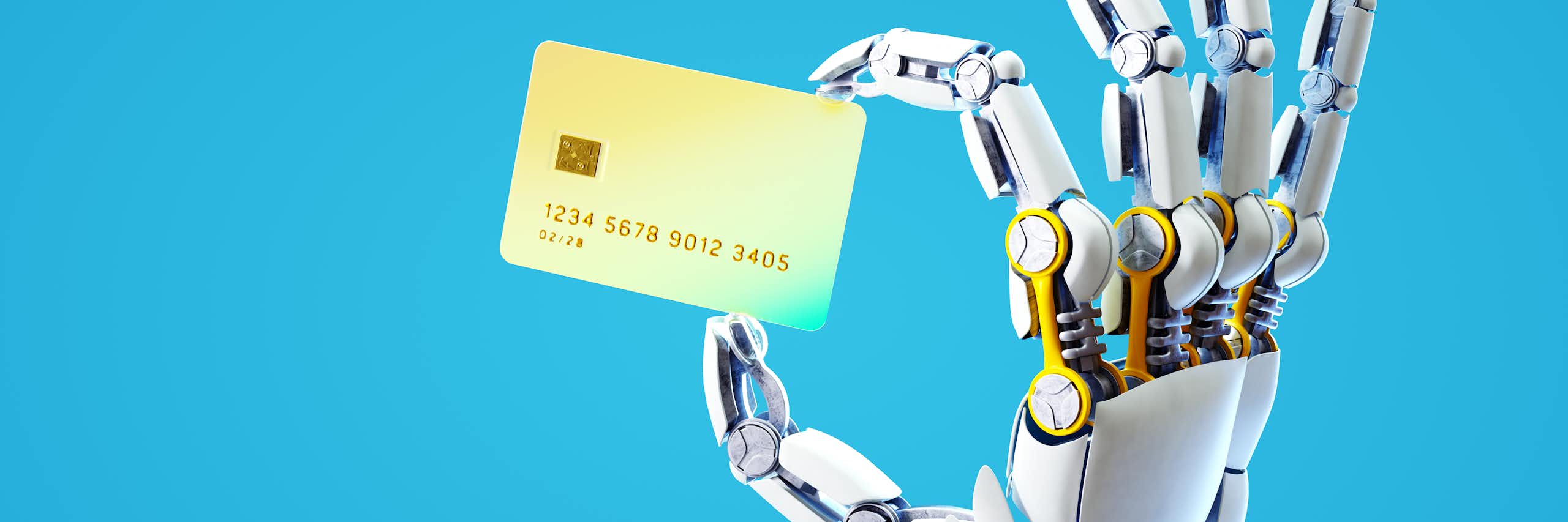 a robotic hand holds a credit card