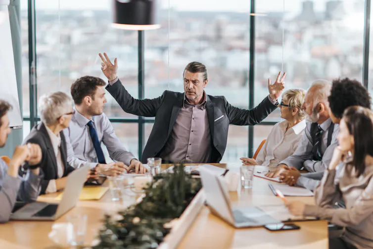 Frustrated CEO is angry at his colleagues during a meeting in the office.