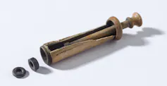 A photo of an old ivory syringe, used by a surgeon abord the HMS Pandora.