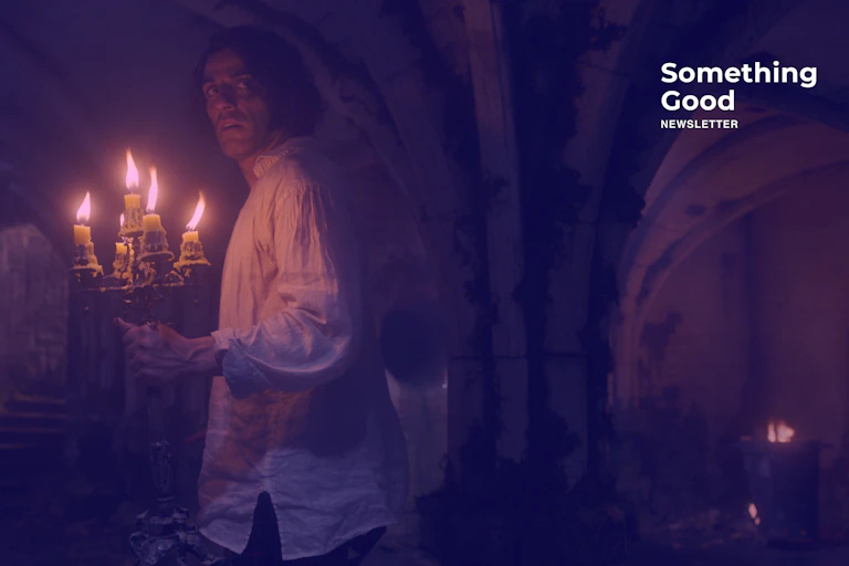 Victor Frankenstein holding candles in a basement.