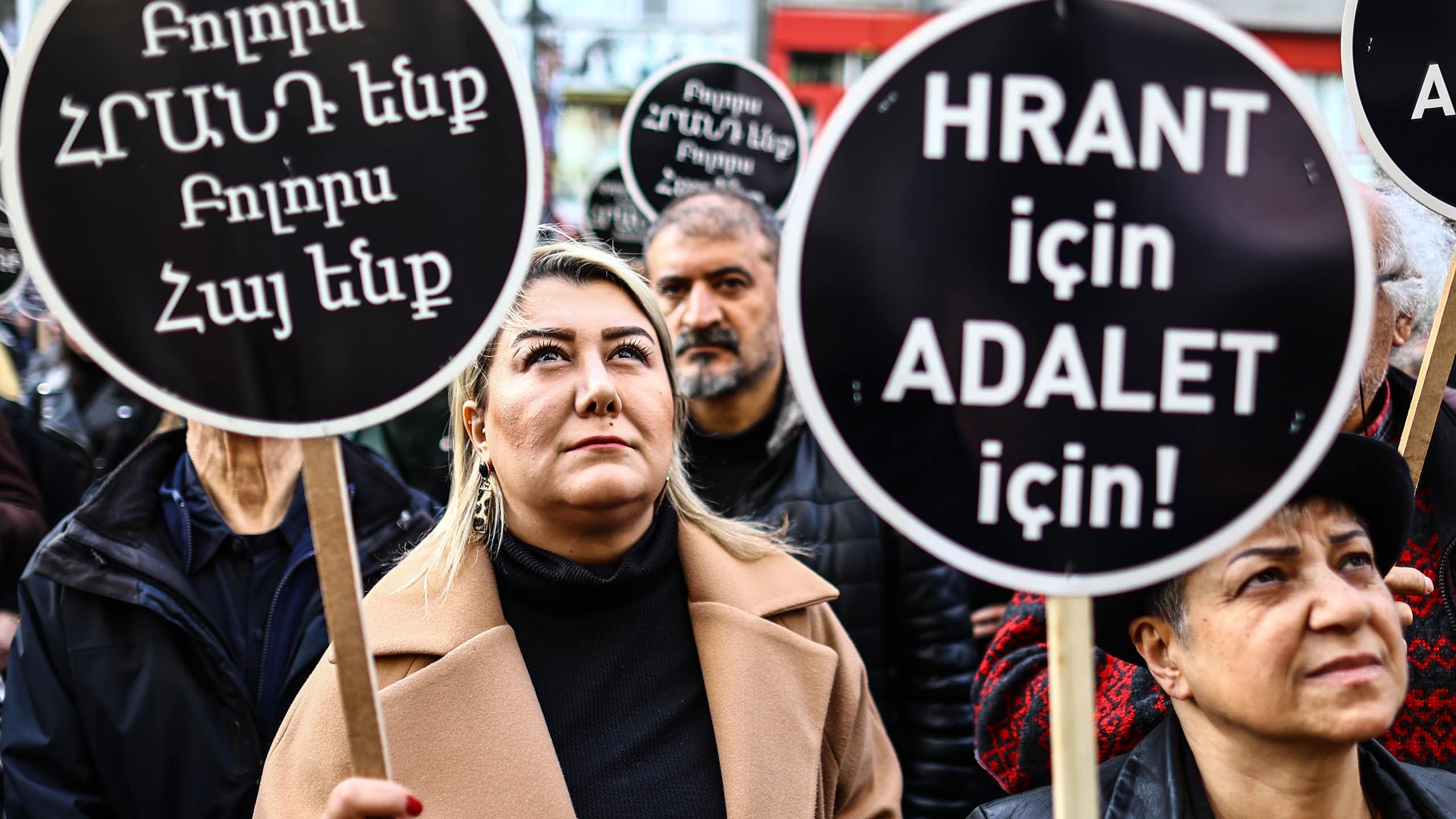 Turkish people hold banners reading 'We all are Hrant and Armenian' during a rally.
