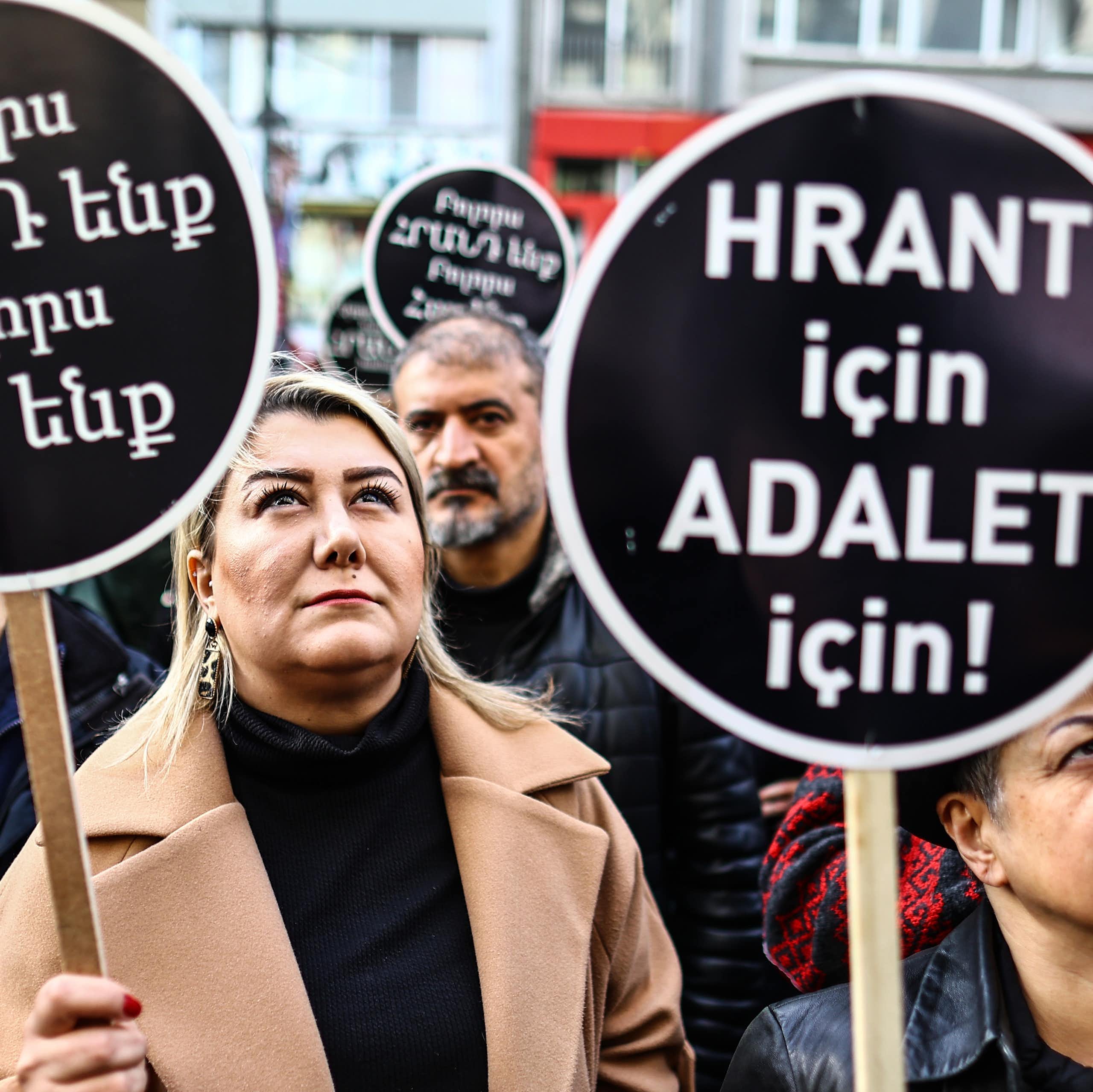 Turkish people hold banners reading 'We all are Hrant and Armenian' during a rally.