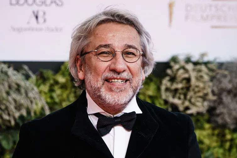 Turkish journalist Can Dündar poses on the red carpet.