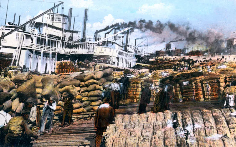 Colorful drawing of people loading bales of cotton onto steamboats.