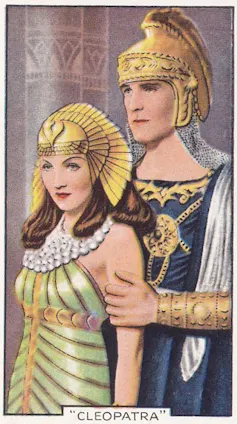 A colorful drawing of a young queen with a gilded headdress being embraced from behind by a man wearing a gilded helmet.