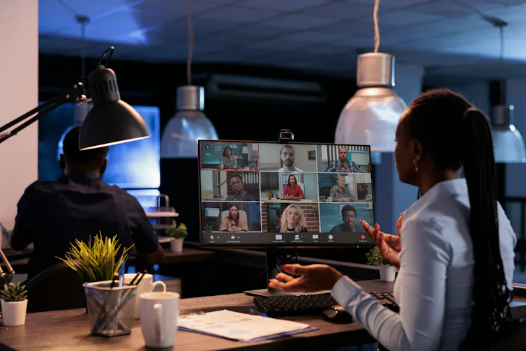 A woman sitting in front of a computer speaks while on a video call
