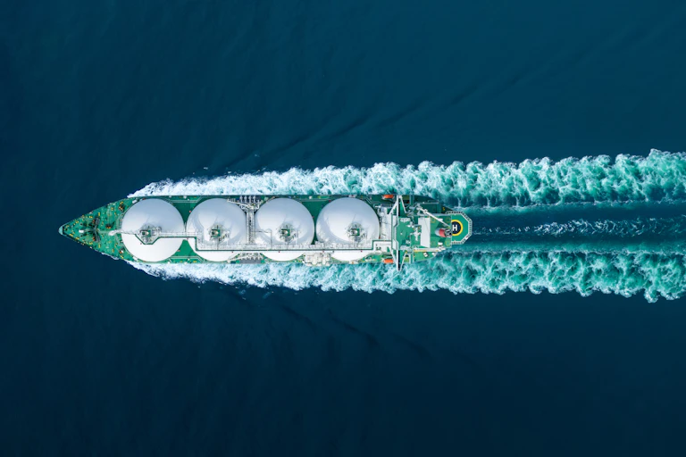 a LNG tanker seen from above leaving a wake.