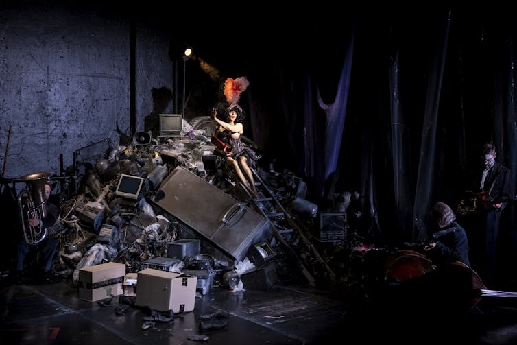 Meow on a pile of junk.