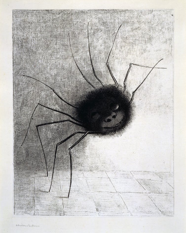 Drawing of a smudgey black spider with a smiling face