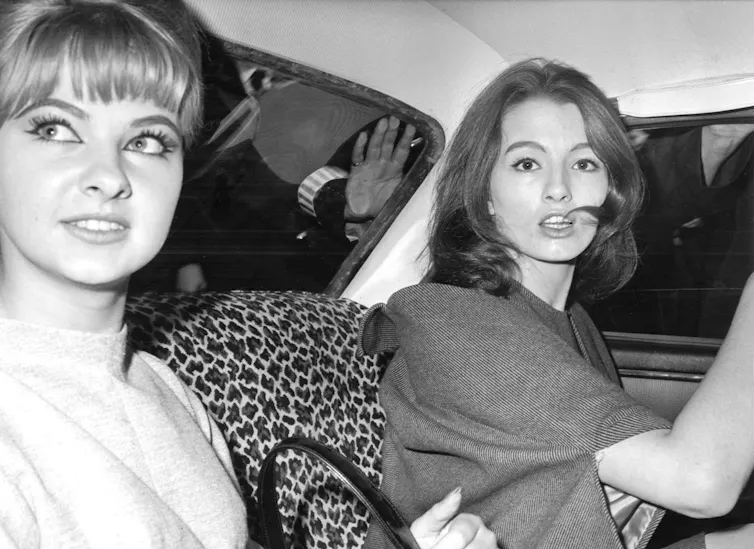 Christine Keeler and Mandy Rice-Davies in the back of a car