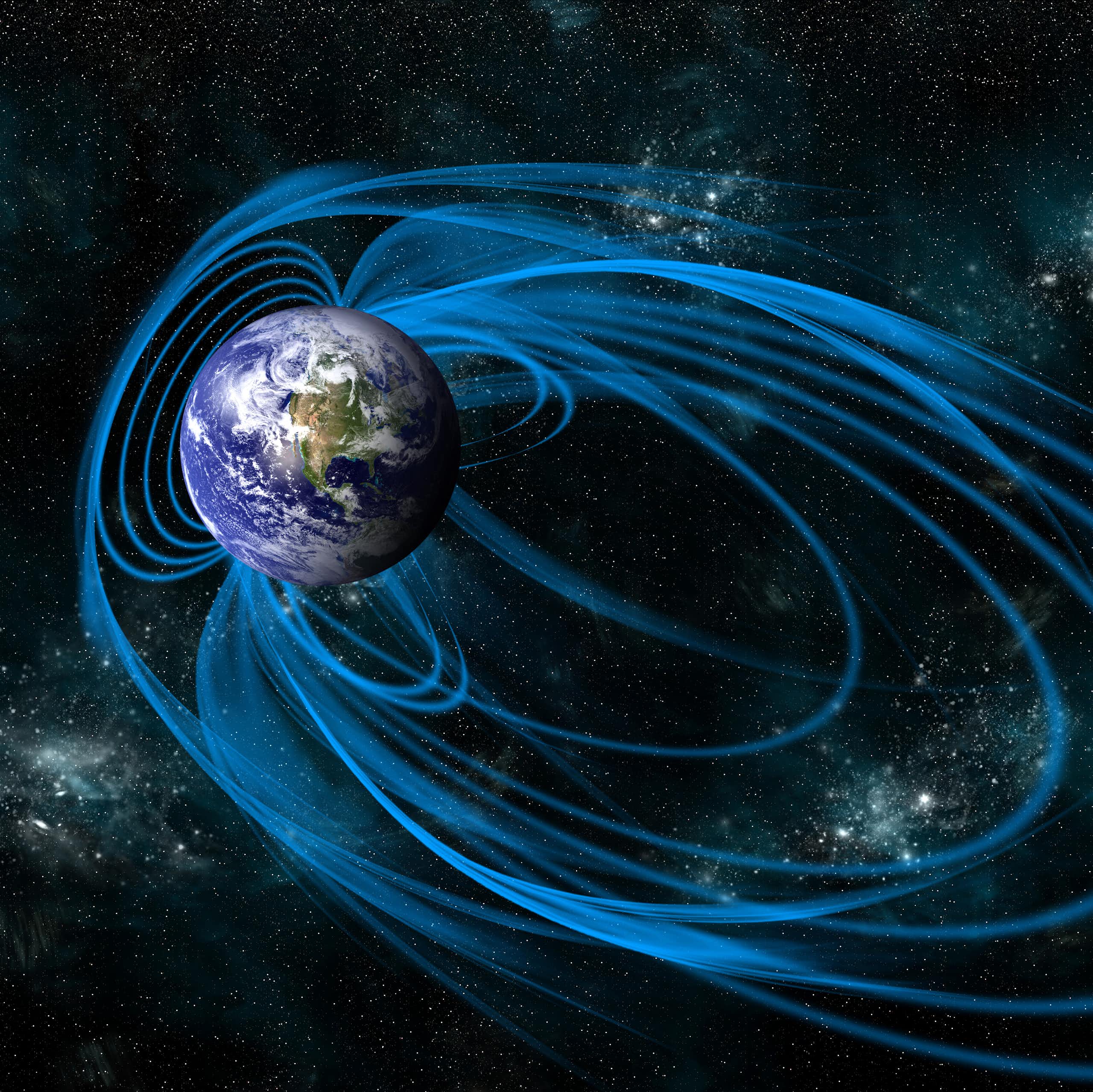 La Terre dans l'espace, avec son champ magnétique représenté par des lignes bleues.