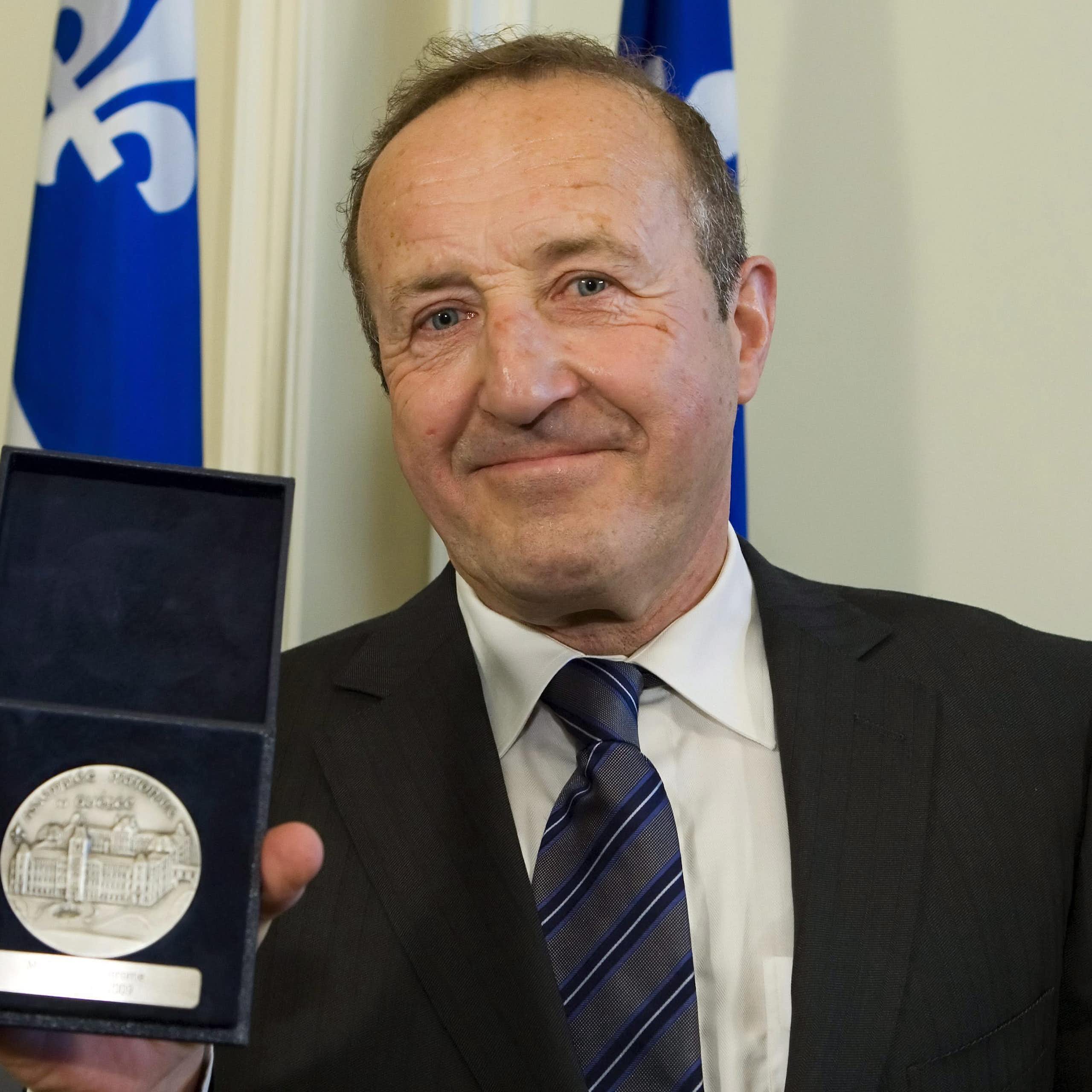Le présentateur de télévision Bernard Derome tient sa Médaille d'honneur