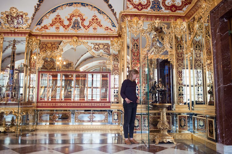 An employee stands in the Jewel Room of the Historical Green Vault at the Zwinger Palace in Dresden