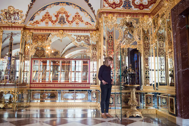 An employee stands in the Jewel Room of the Historical Green Vault at the Zwinger Palace in Dresden