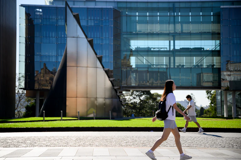 A student walks past a university building.