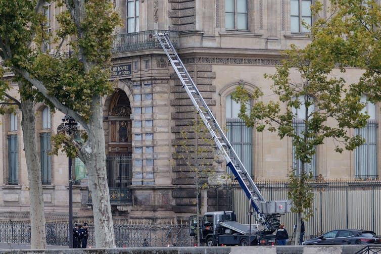 A ladder leaning against the Louvre