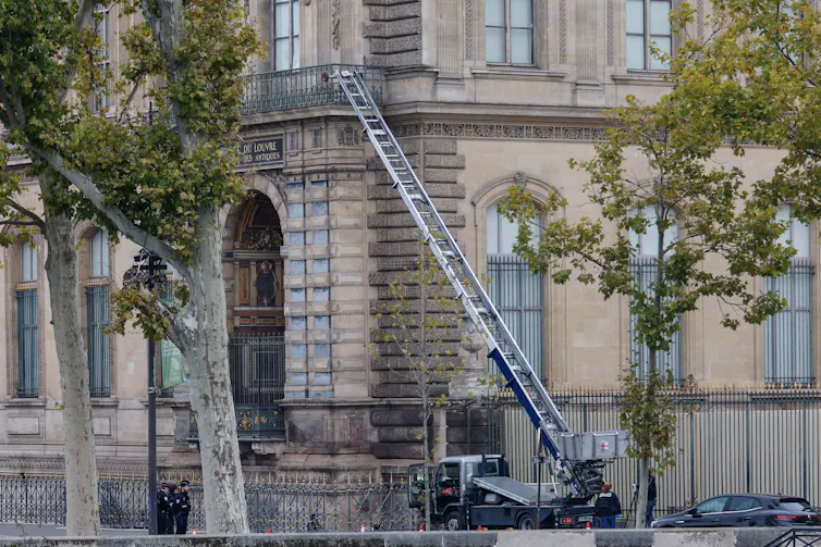 A ladder leaning against the Louvre